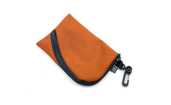 A Mini Ghost Whale Pouch in Burnt Orange.